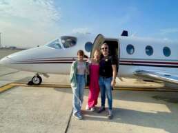 Family in front of a private jet